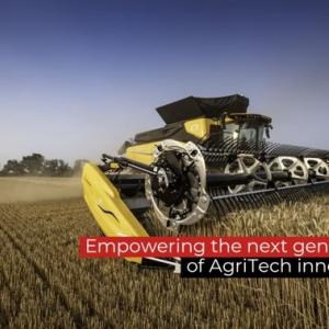 A piece of agricultural equipment in a crop field with the text "empowering the next generation of AgriTech Innovators"