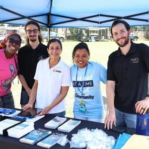 volunteers at a booth