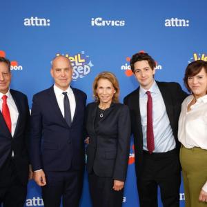 five people stood together in front of a nickelodeon logo backdrop