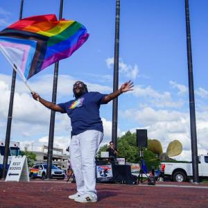 A person waving a pride flag