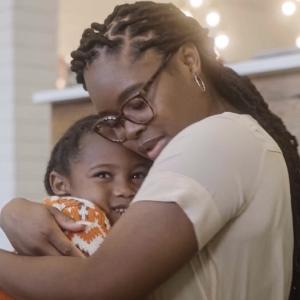 Photo of Perseverance Narcisse hugging her son.