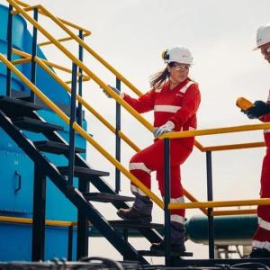 Two Veolia workers speaking to one another 
