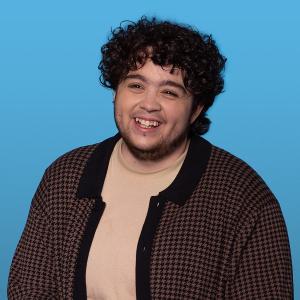 headshot of Teodoro Puig against a blue background