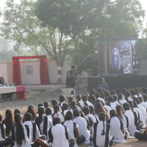Group of students sitting in front of projector screen