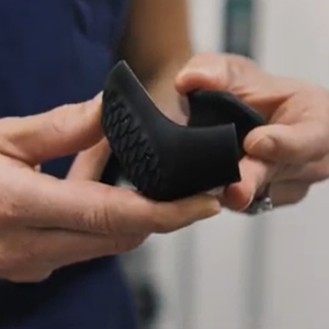 Hands holding the 3D printed boot