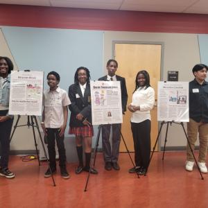 Students stood near their work 