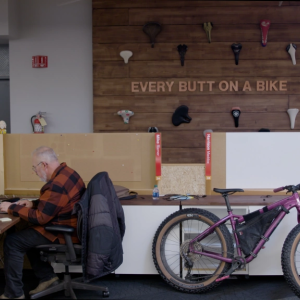 Person at office desk with bike next to them