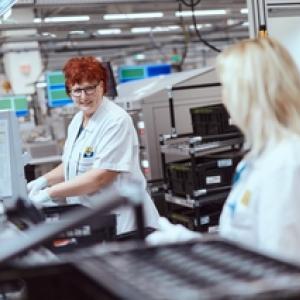 Two female HARMAN technicians working in a lab.