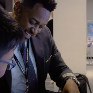 Quincy with a student in a classroom.