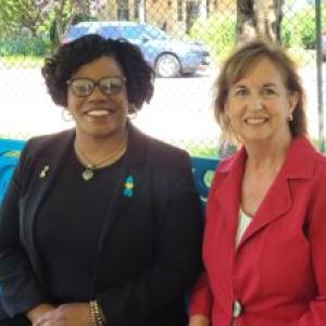 two people sitting on the new Aflac park bench