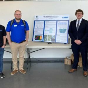 Students and faculty with a project