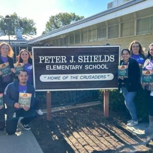 Rancho Cordova volunteers by elementary school entrance sign
