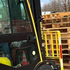 Forklift moving wooden pallets