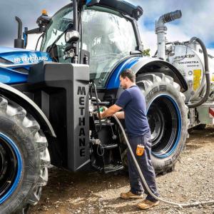 A person refueling a tractor