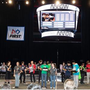 people stood in front of a crowd at the FIRST Robotics Regional Competition in Colorado