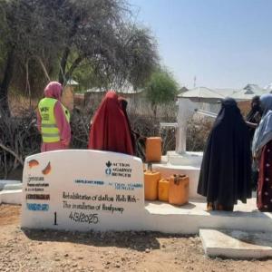 Women gather at the rehabilitated well in Wajid. 