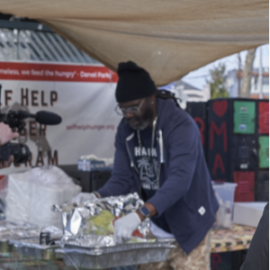 Person packing up food in aluminum foil