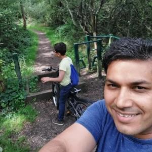 Sandeep shown with his son on a bike path.