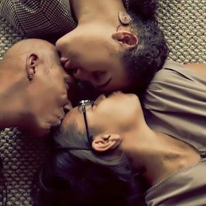 Ricki with her two daughters, Amanda and Hayley lying on the floor, kissing each others' foreheads