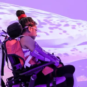 person in wheelchair looking at screen