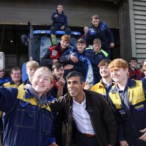 UK Prime Minister, Rishi Sunak, taking a photo with New Holland engineering apprentices 