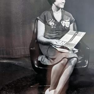 Robin Nicholson in a TV interview, holding 4H materials