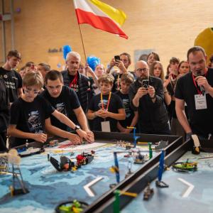 People compete at robotics league