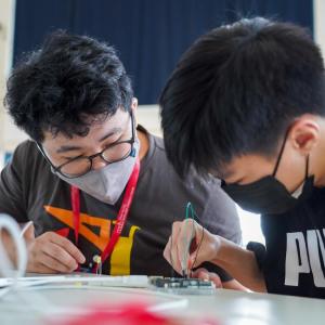 two students work on robotics