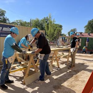 Wesco volunteers working on a house frame.