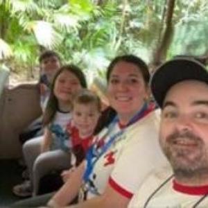 Rowan and his family on an amusement park ride.