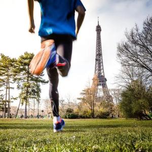 A person running towards the Eiffel tower 