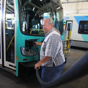 Dave Davis, chair of the Santa Barbara MTD Board of Directors, begins to charge one of the agency's new buses.