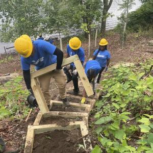 SCA Team members working on steps in a park.