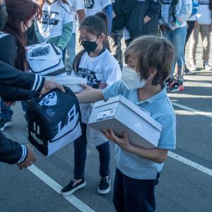 LA Kings staff and volunteers pass out shoes and lunch boxes to students at Longfellow Elementary School in Los Angeles. 