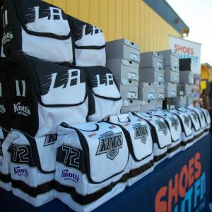 LA Kings lunchboxes and adidas sneakers are stacked prior to distribution to students at Longfellow Elementary School in Compton, Calif. 