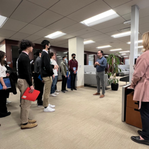 Person speaking with a group of students