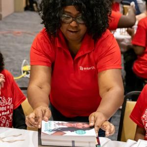 instructor working with two students on STEM activity
