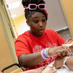 three students working on a STEM activity