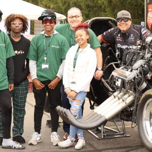 Students pose with Cruz Pedregon and his 'Nitro Funny Car'