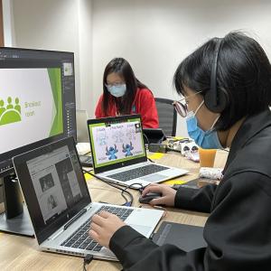 two people working on their computers