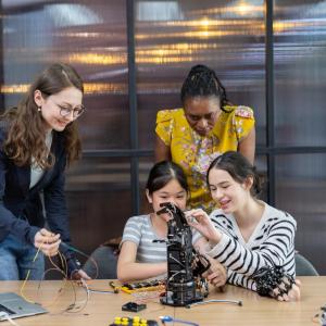 Tw girls building machines with instructors