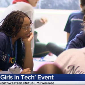 Young women in lanyards working together at a group event