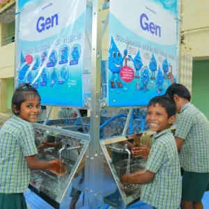 School students washing their hands under a running tap from the AquaTower system