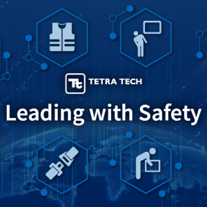 Blue graphic with health and safety icons and the words “Leading with Safety” 
