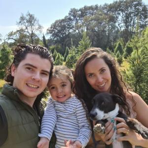 Man and woman holding daughter and dog