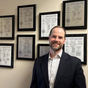 Adam Sanders in front of the patent wall outside the Dexterous Robotics Laboratory at NASA's Johnson Space Center in Houston. Sanders was awarded 11 patents while working at NASA.