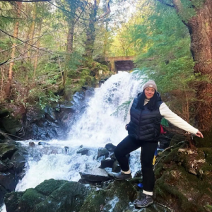 Sarah shown by a mountain stream.