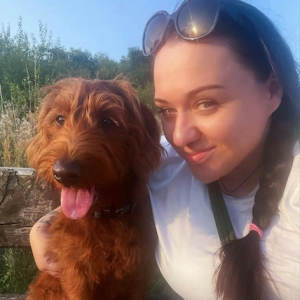 Close up of Sarah with her dog.