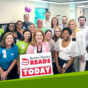 Group photo in front of sign that reads "Better Basics READS TODAY"
