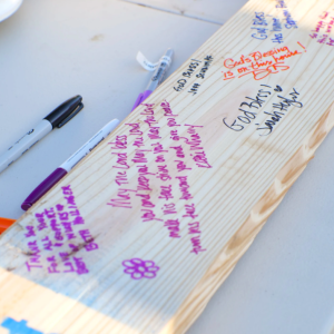 a piece of wood with notes and messages written on it